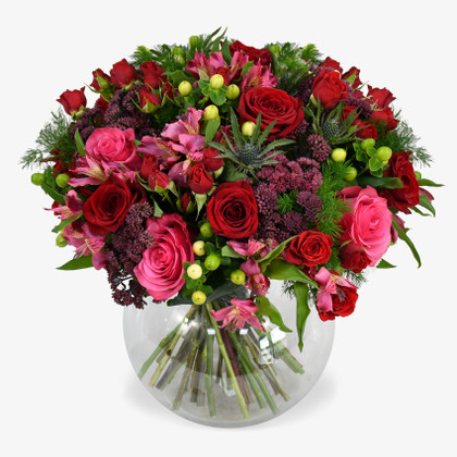 Crimson roses combine with velvety sedum to make a rich and moody colour palette.